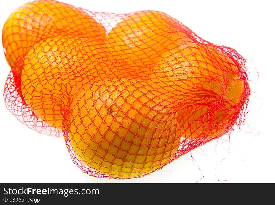 Isolated oranges on a white background in mesh bag