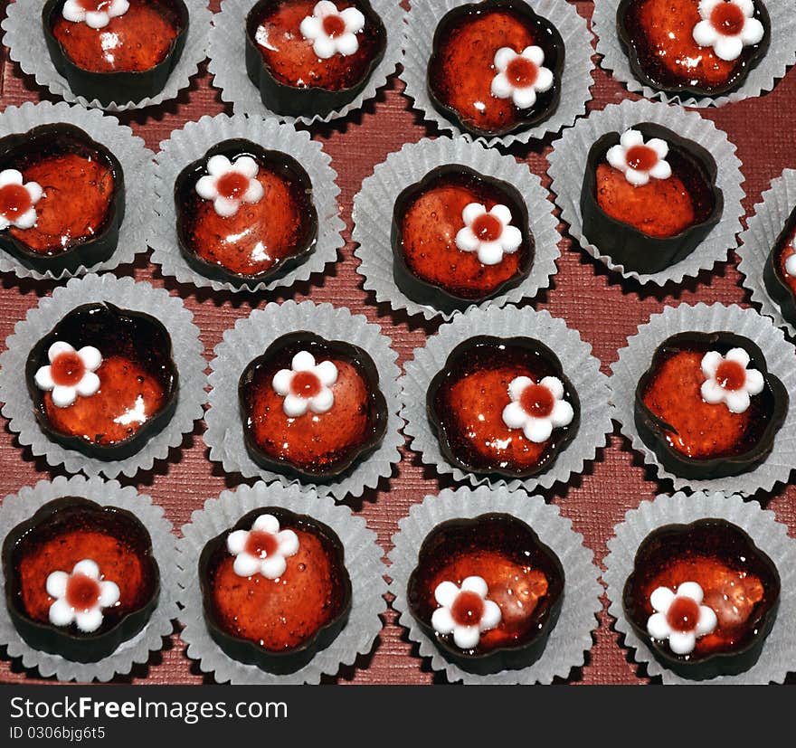 Plate with red chocolates cookies. Plate with red chocolates cookies