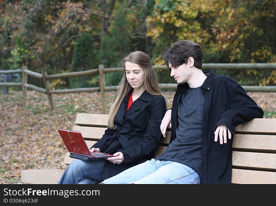 Couple at the park with laptop. Couple at the park with laptop