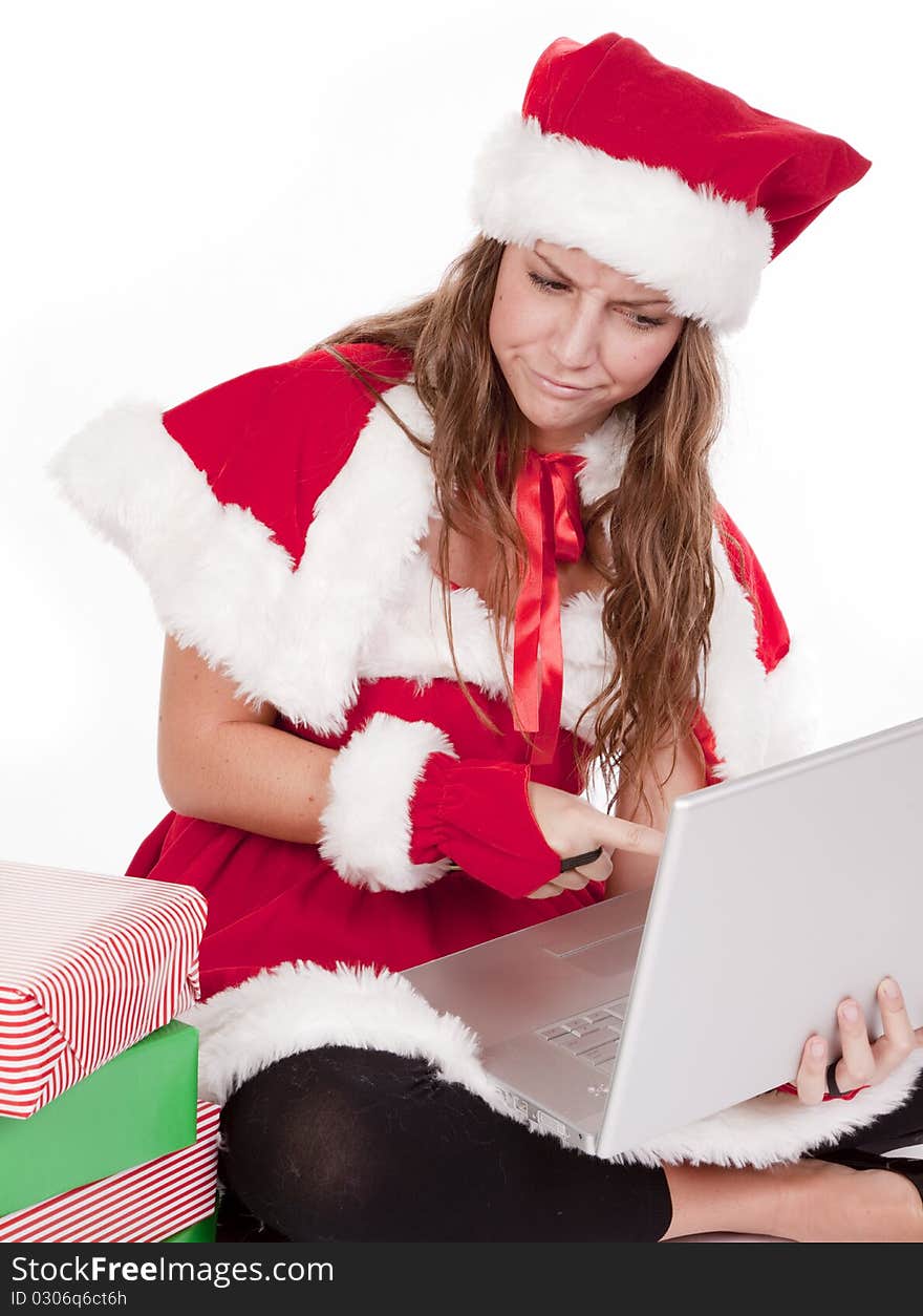 A woman is dressed like santas helper and using a computer. A woman is dressed like santas helper and using a computer.