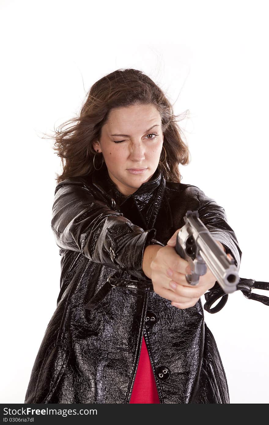 A woman aiming a gun with one eye. A woman aiming a gun with one eye.