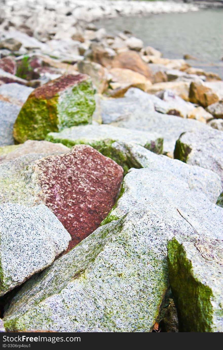 Granite rocks along the bed of the river filled with algae. Granite rocks along the bed of the river filled with algae