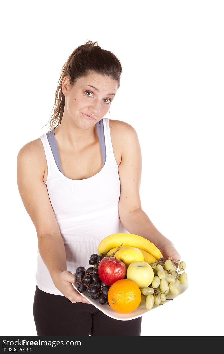 Woman in white tank top not sure about fruit