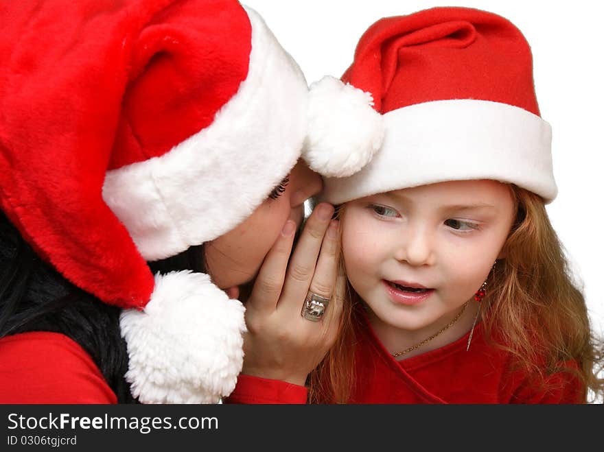 Girl whispers in child ear. Girl whispers in child ear