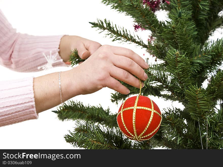 Christmas tree, ball and hand of christmas girl. Isolated.