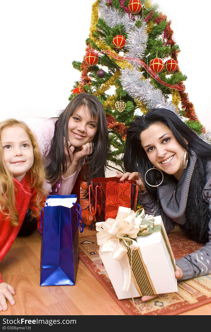 Three young happy womenwhit gift box. Studio shot. White background