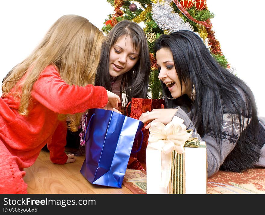 Three young happy women whit gift box. Studio shot. White background