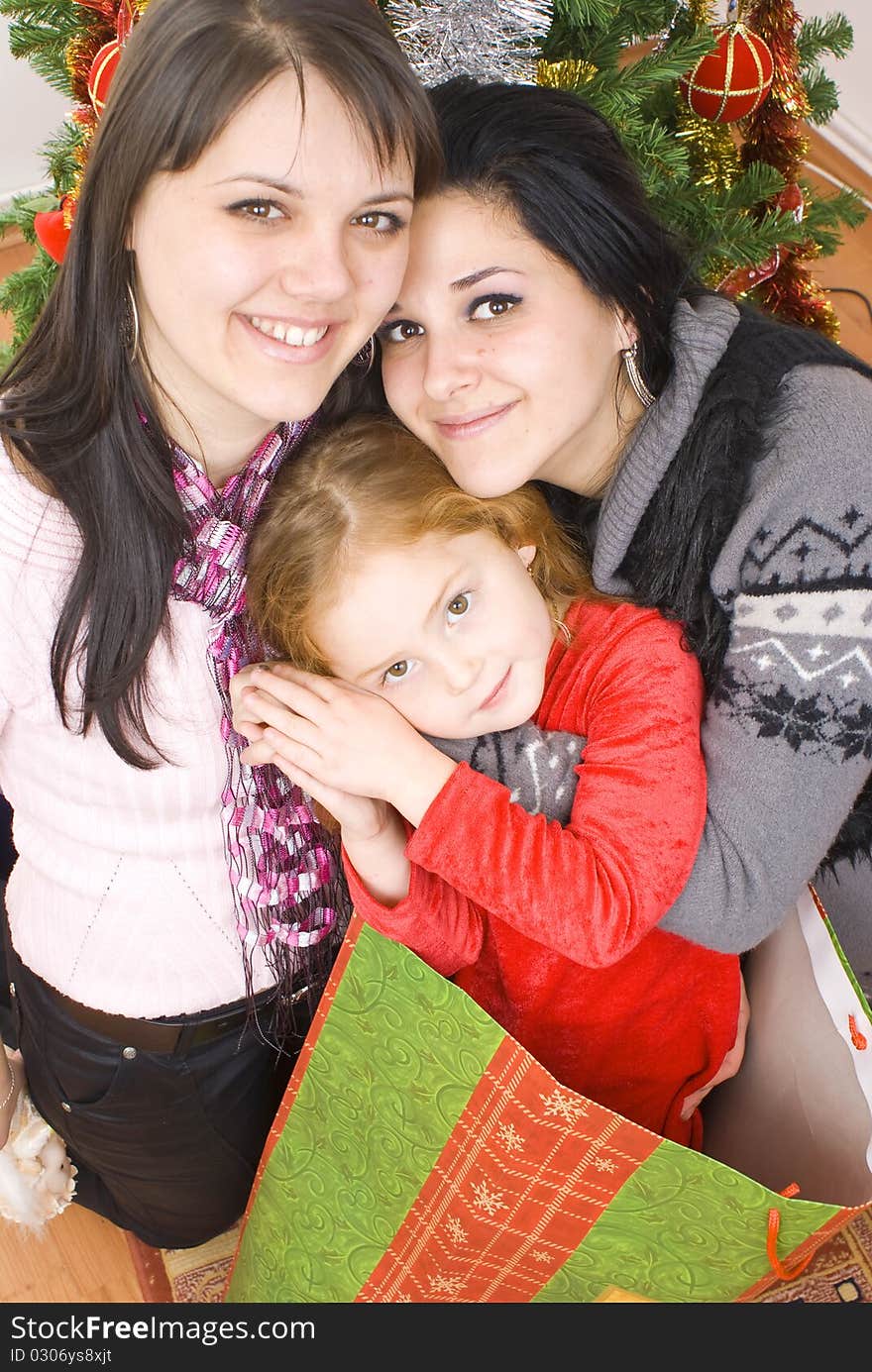 Three young happy women whit gift box. Studio shot