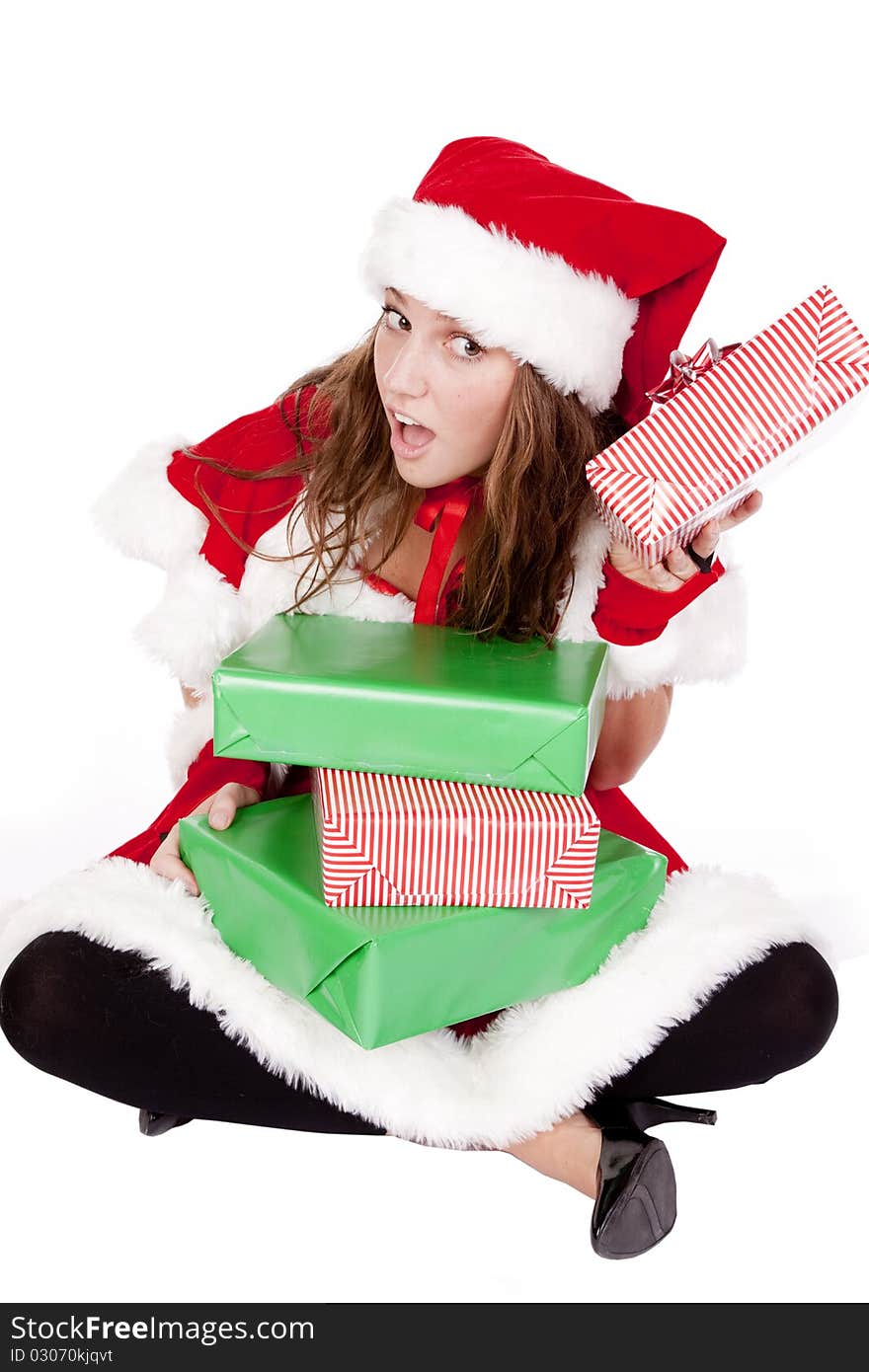 Mrs Santa is sitting on the floor listening to a gift. Mrs Santa is sitting on the floor listening to a gift.