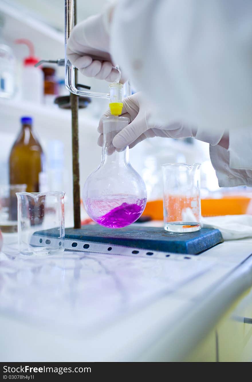 female researcher doing research in a lab (color toned image; shallow DOF)