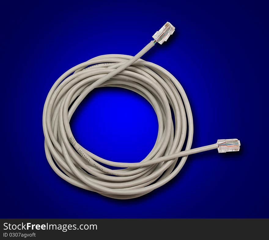 Network cable irregularly wound in a roll on a dark blue background