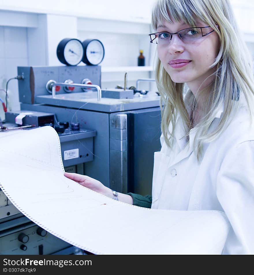 Portrait of a female researcher carrying out research in a chemistry lab (color toned image; shallow DOF)