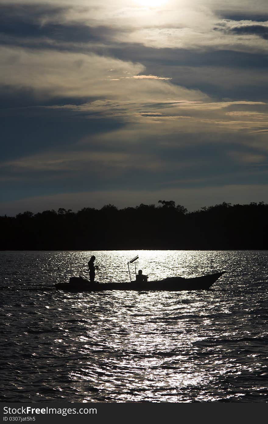 Two fishermen in a boat on the river