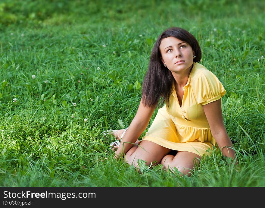 Beautiful young woman relaxing in the grass