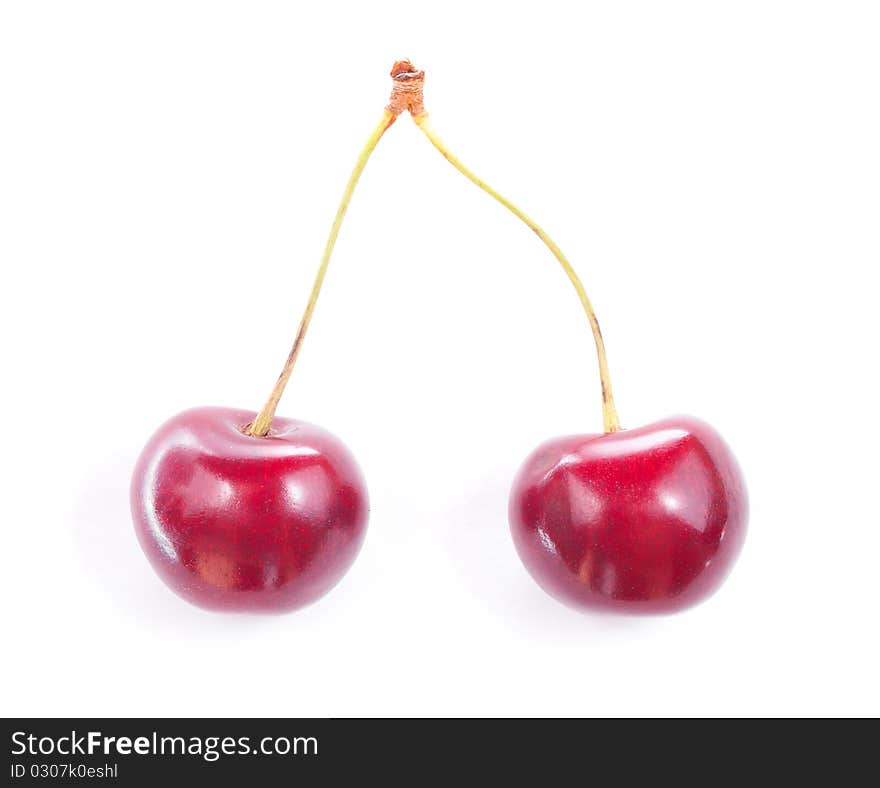 Two colorful red cherries isolated on white background. Two colorful red cherries isolated on white background.