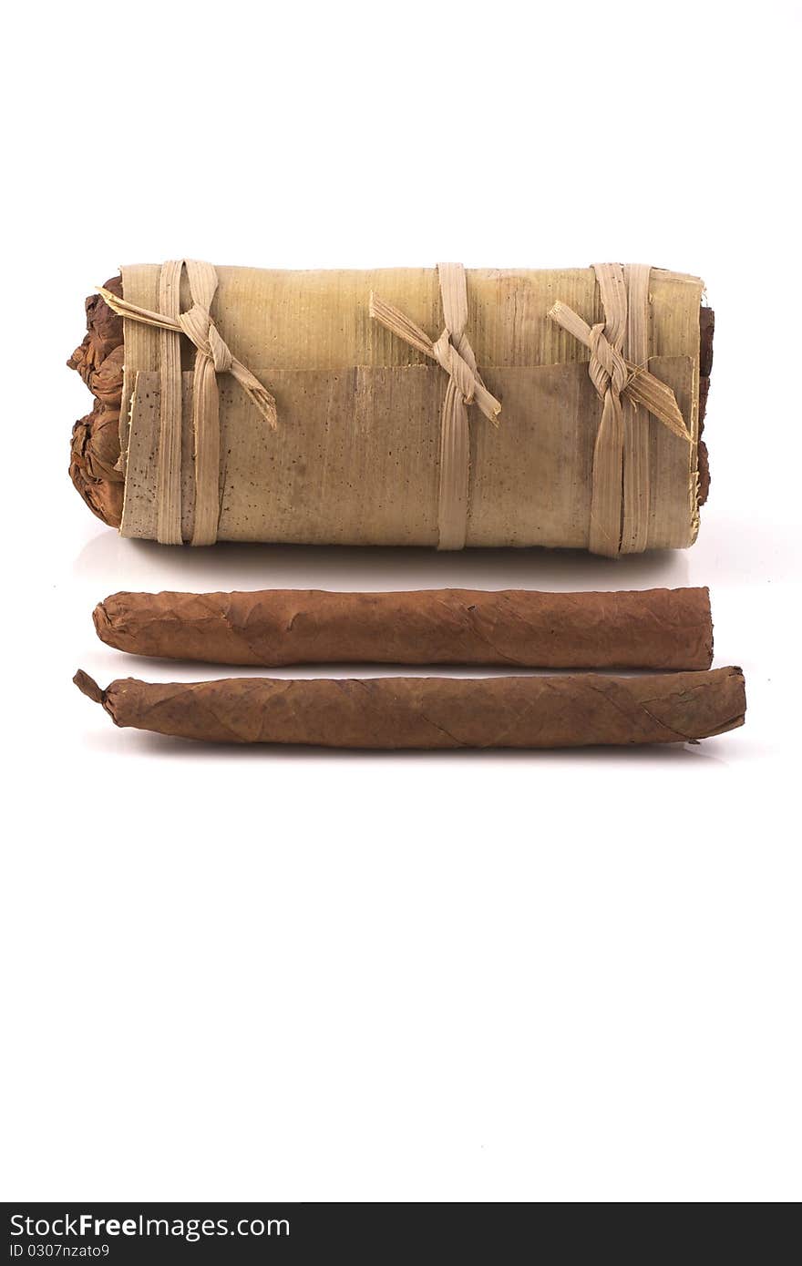 Two hand rolled cigars in front of an authentic cuban humidor, a banana leaf, isolated on a white background