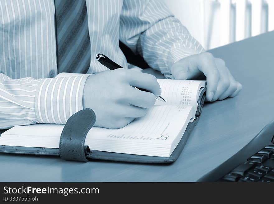 A young business man working in an office at his workplace.