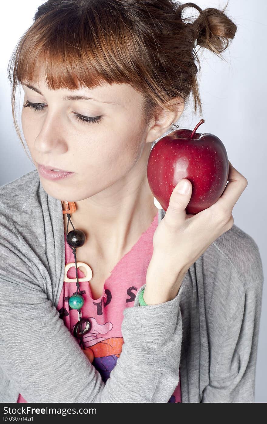 Girl with apple on white background