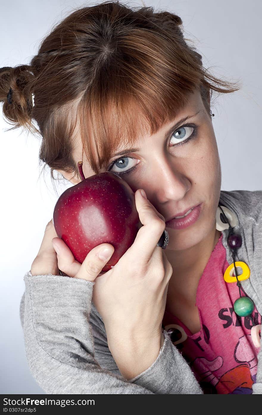 Girl with apple on white background