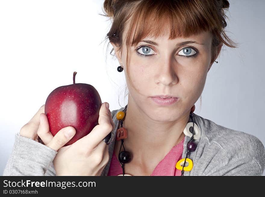 Girl with apple on white background