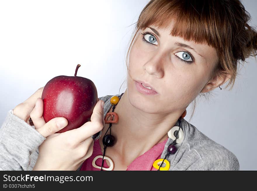 Girl with apple on white background