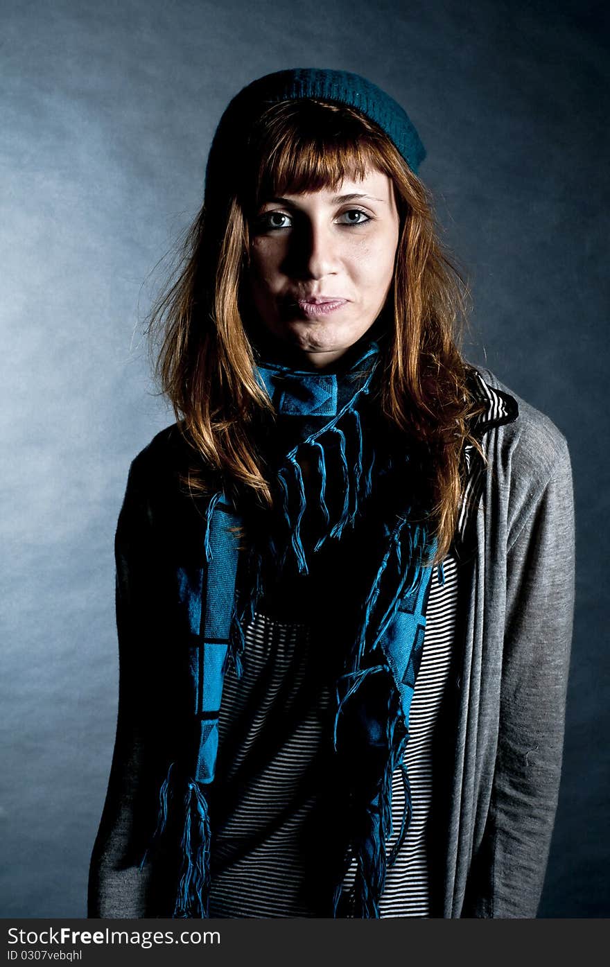 Beautiful girl with scarf and hat on a black background