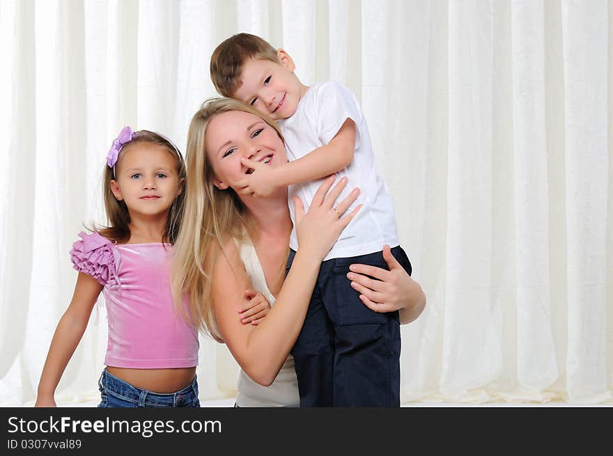 A young mother, her daughter and son having fun together