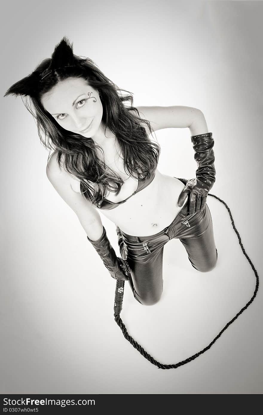 catwoman in black leather pants with whip. Black and white. catwoman in black leather pants with whip. Black and white