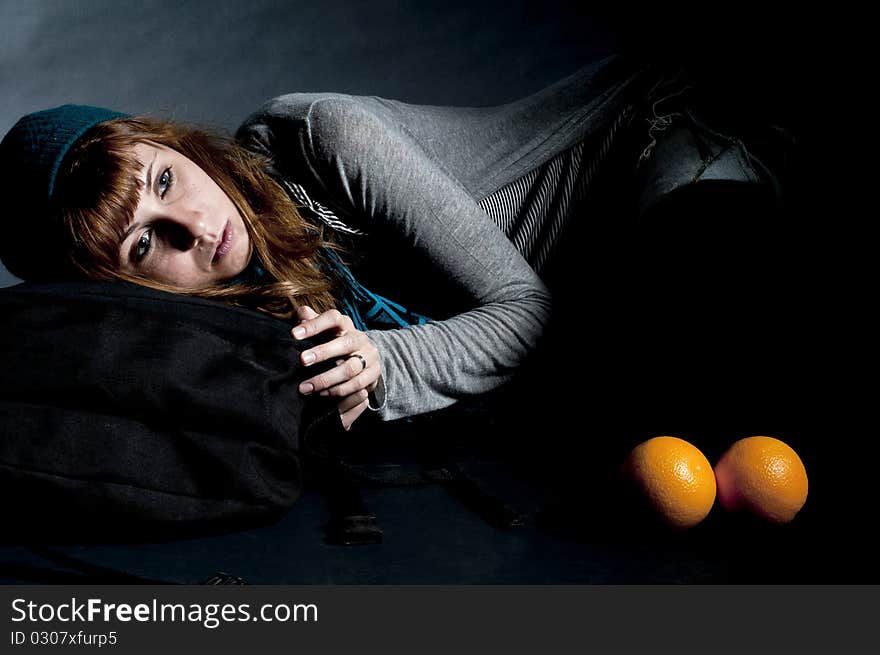 Beautiful girl with scarf and hat and oranges