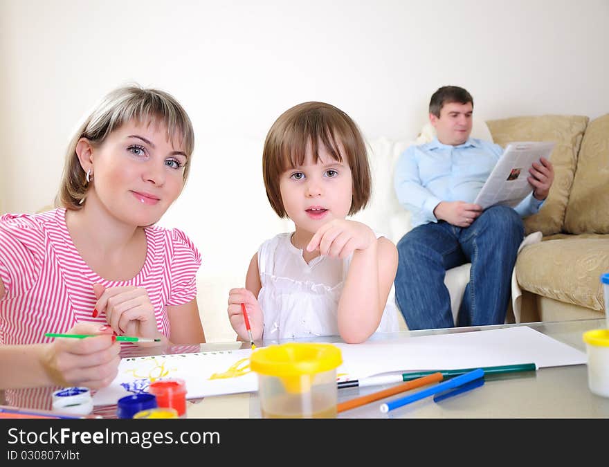 Mother and daughter together paint an album and have fun together.