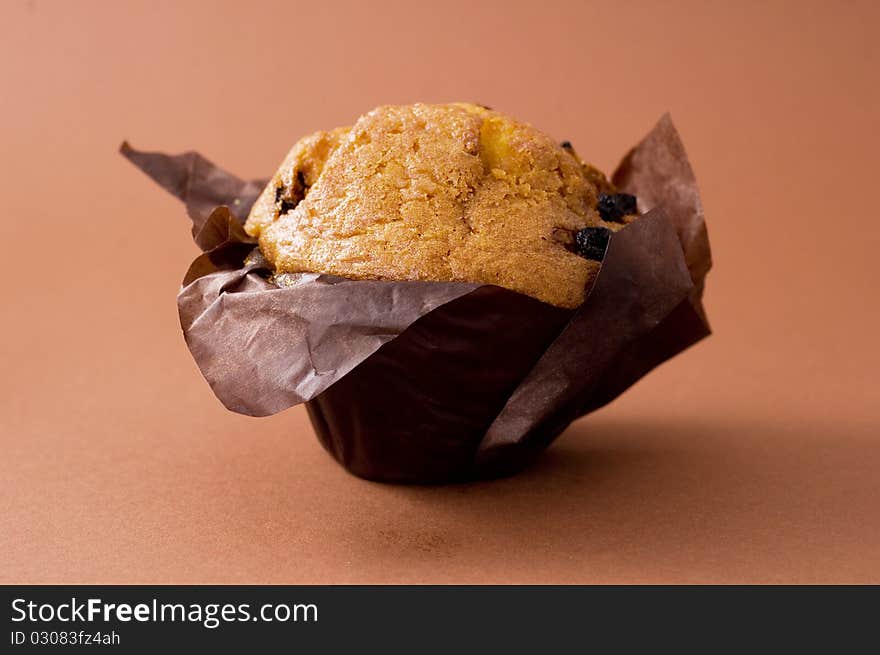 Cuocake with rasin on brown background