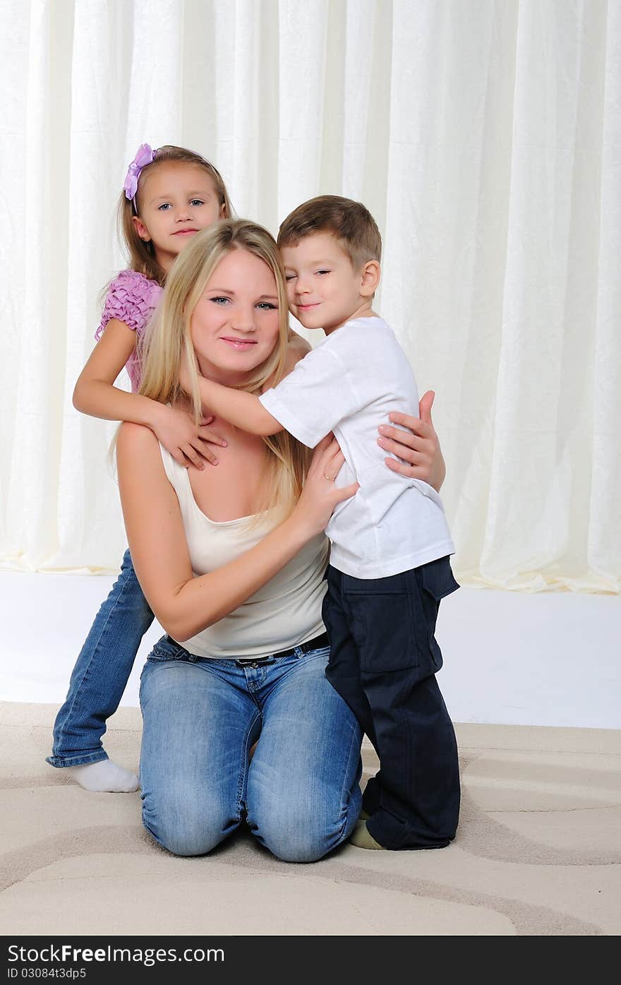 A young mother, her daughter and son having fun together