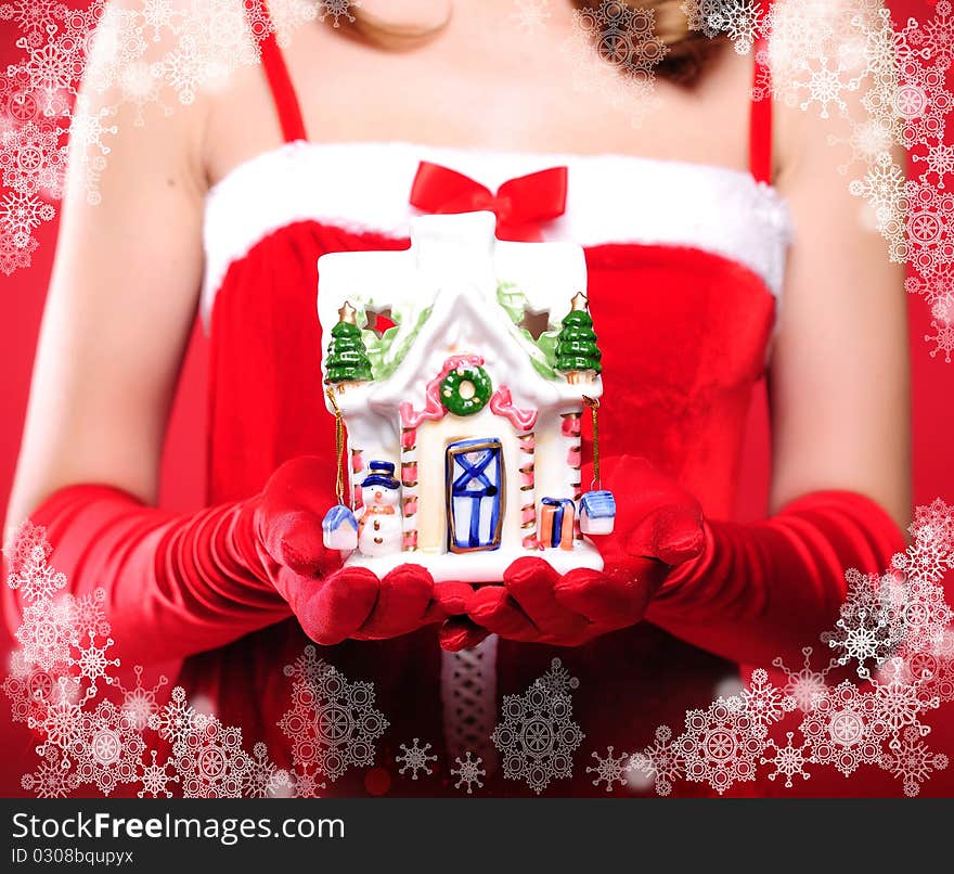 Portrait of a young girl dressed as Santa Claus on a red background. Girl gives gifts. Happy New Year and Merry Christmas!