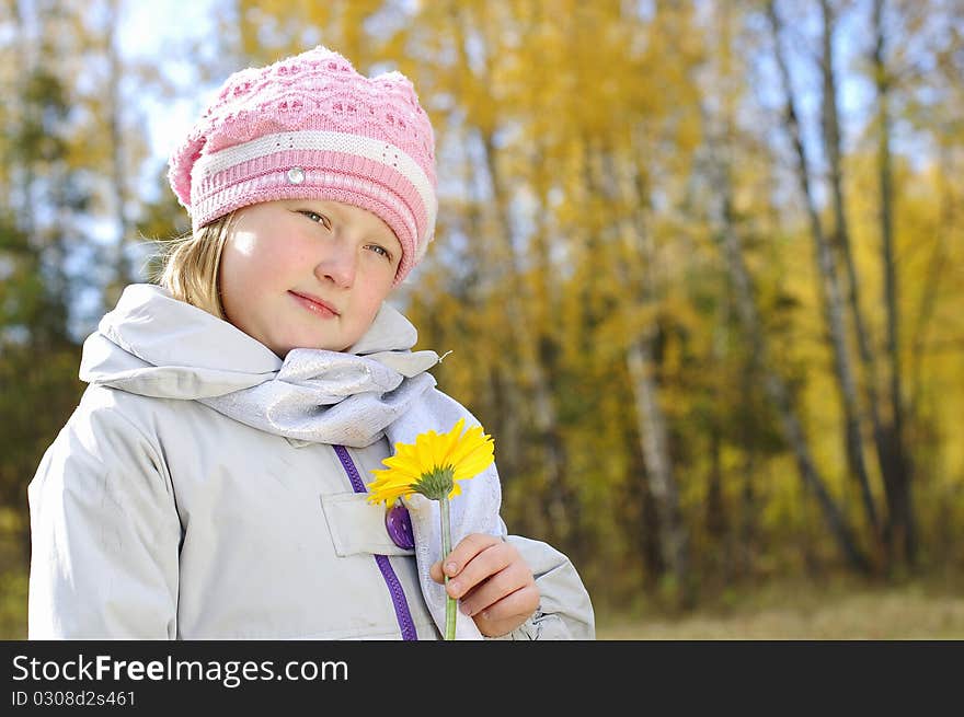 Little girl with a yellow flower