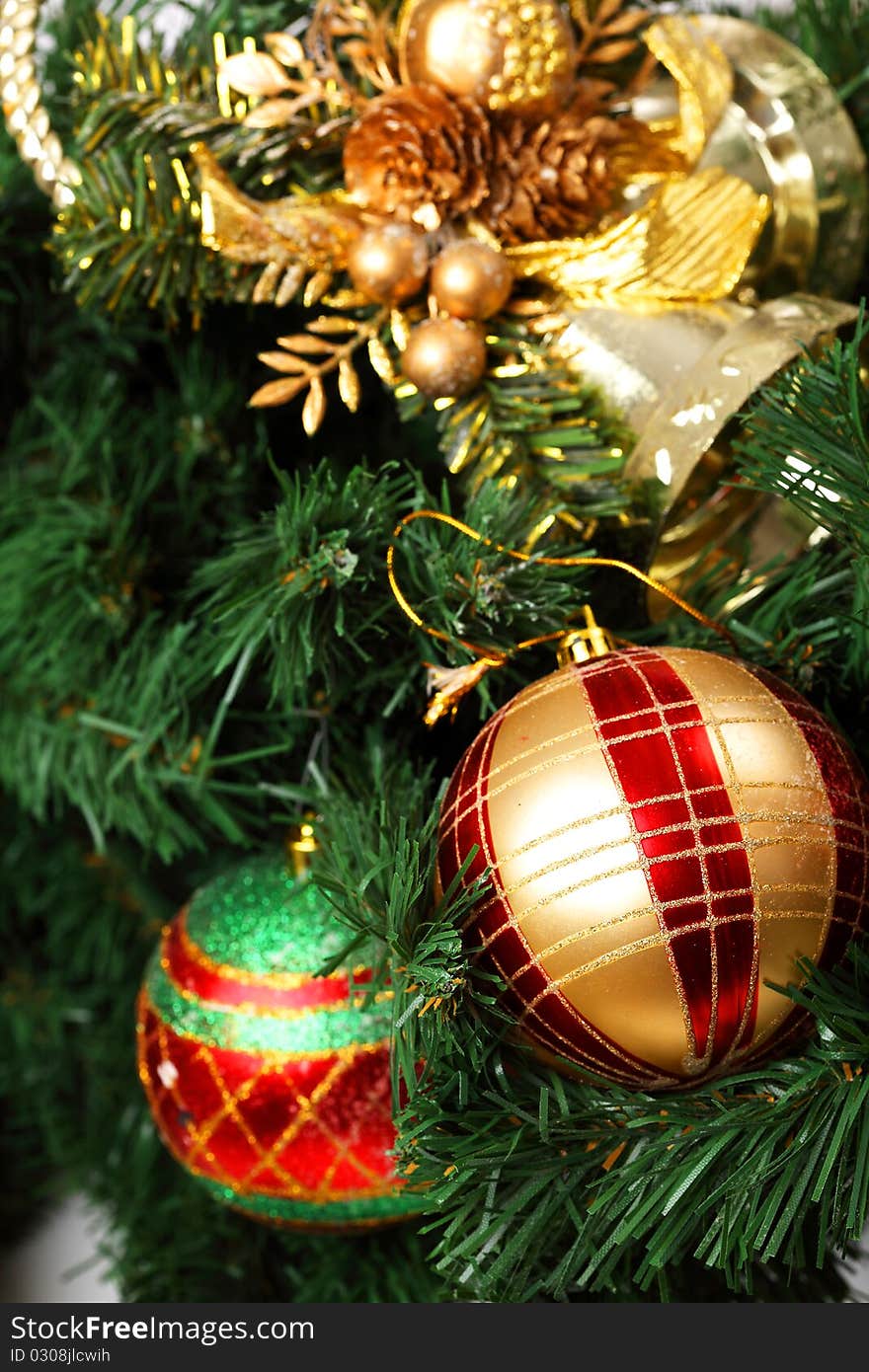 Detail of the Christmas decoration painted in red and gold, on the Christmas tree