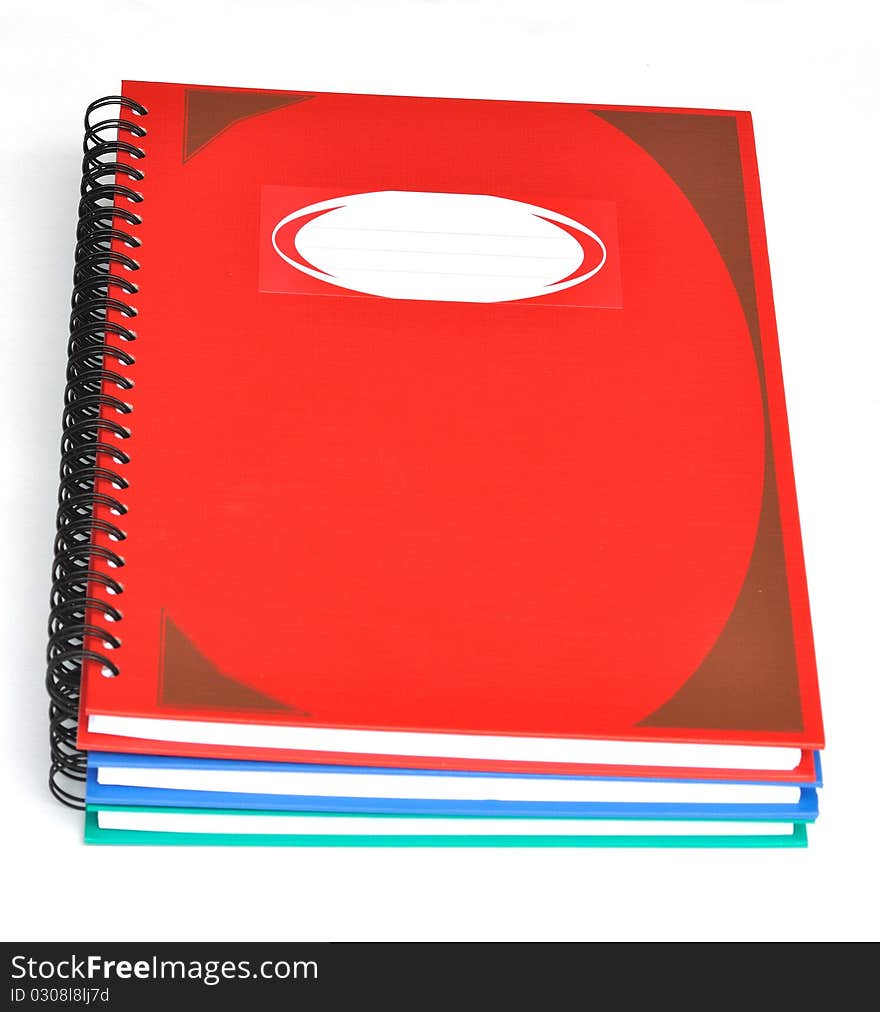 Stack of three color rectangular notebooks. Stack of three color rectangular notebooks.