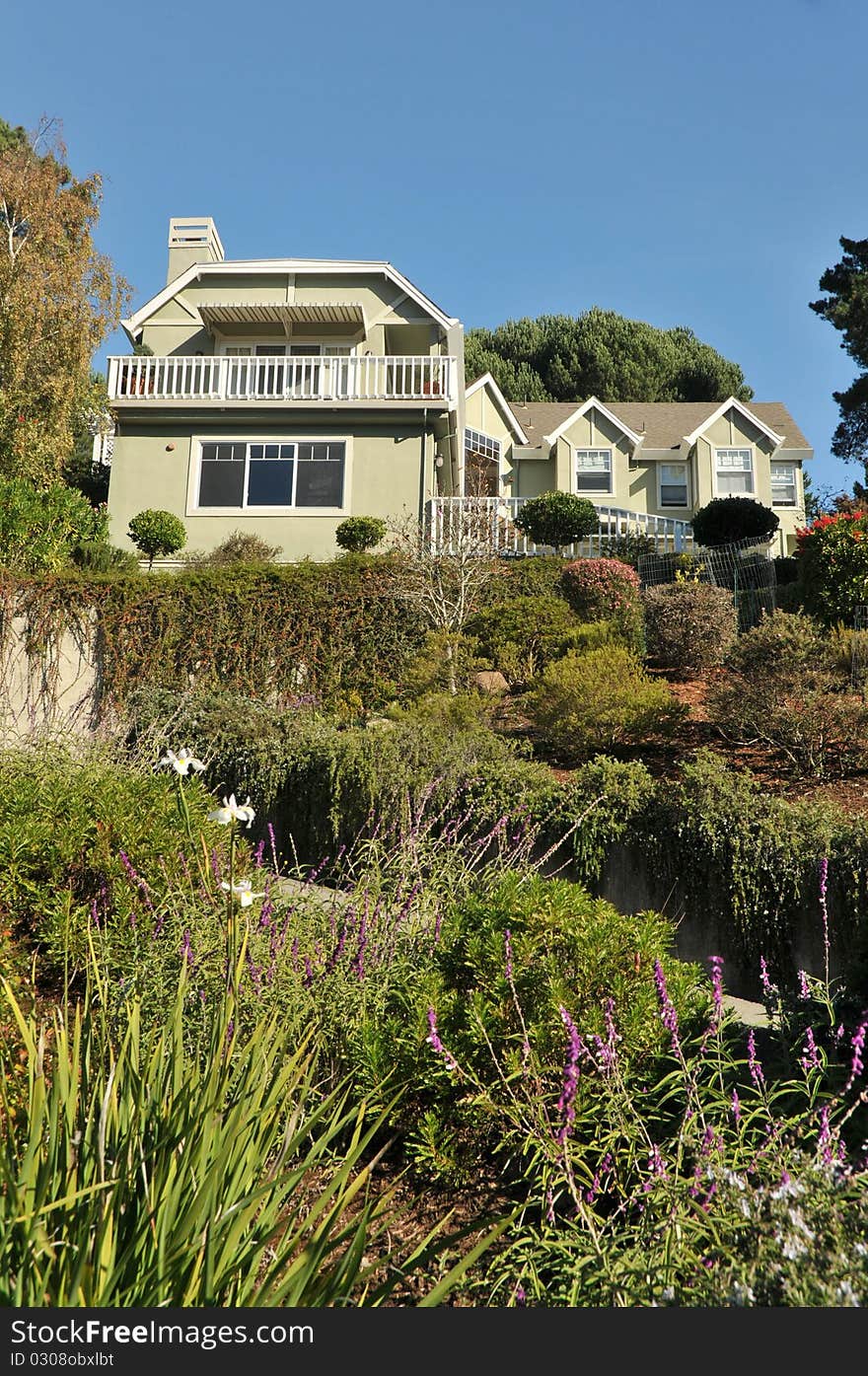 House at top of hill with landscaping