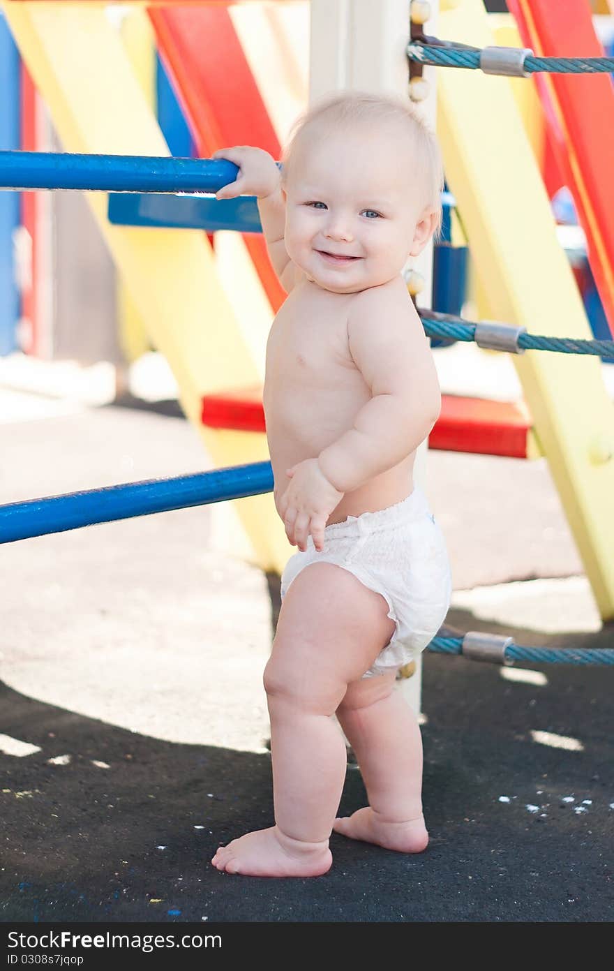 Littele baby play on playground.