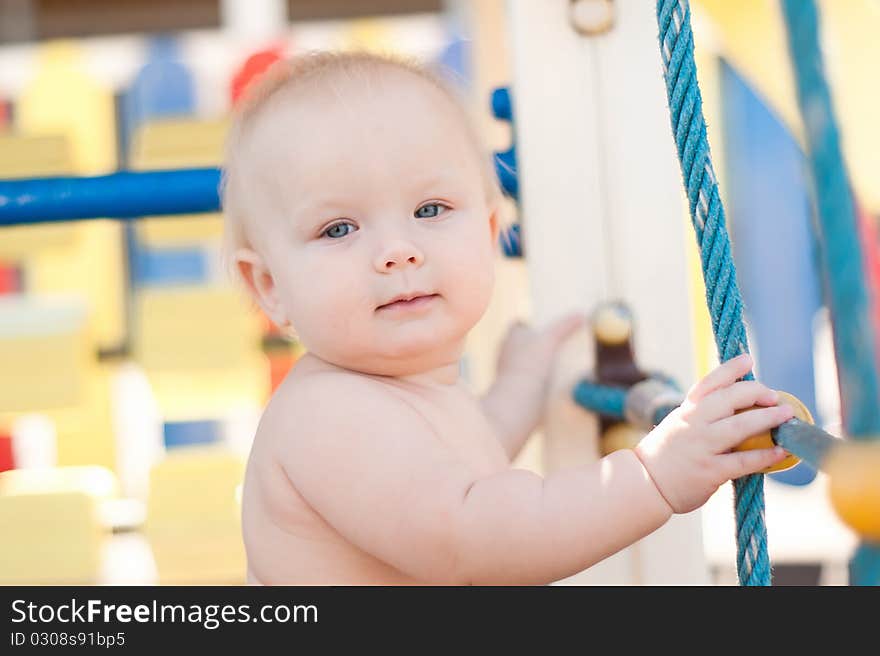 Littele baby play on playground.