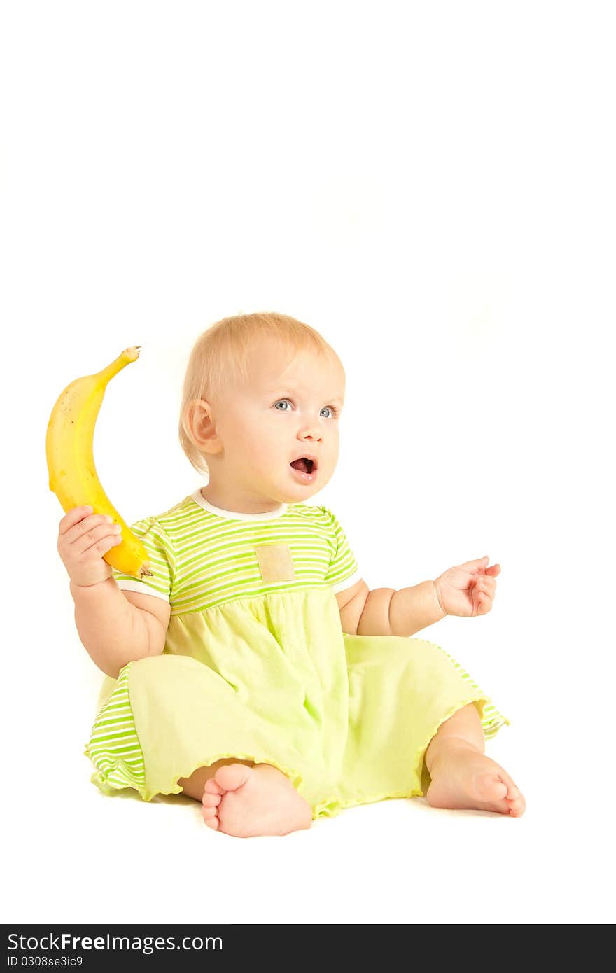 Young little baby eat yellow banana on white.