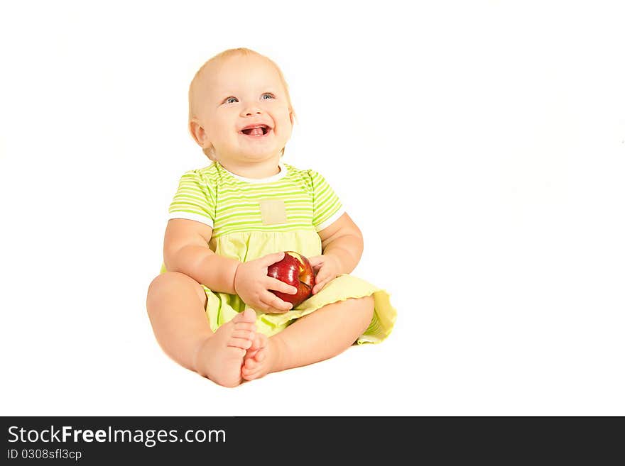 Young little baby eat red apple on white.