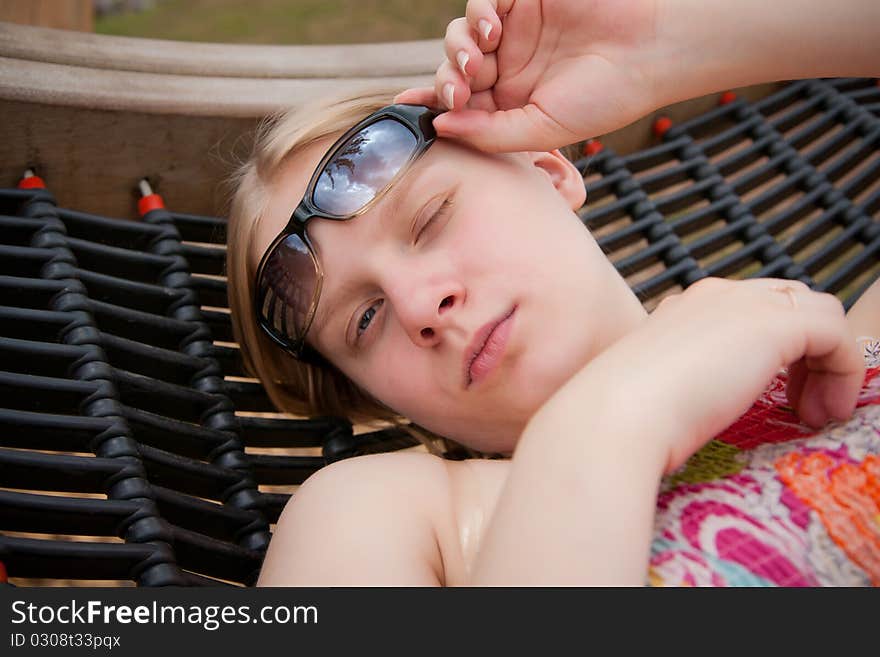 Beautiful woman relaxing in hammock in park