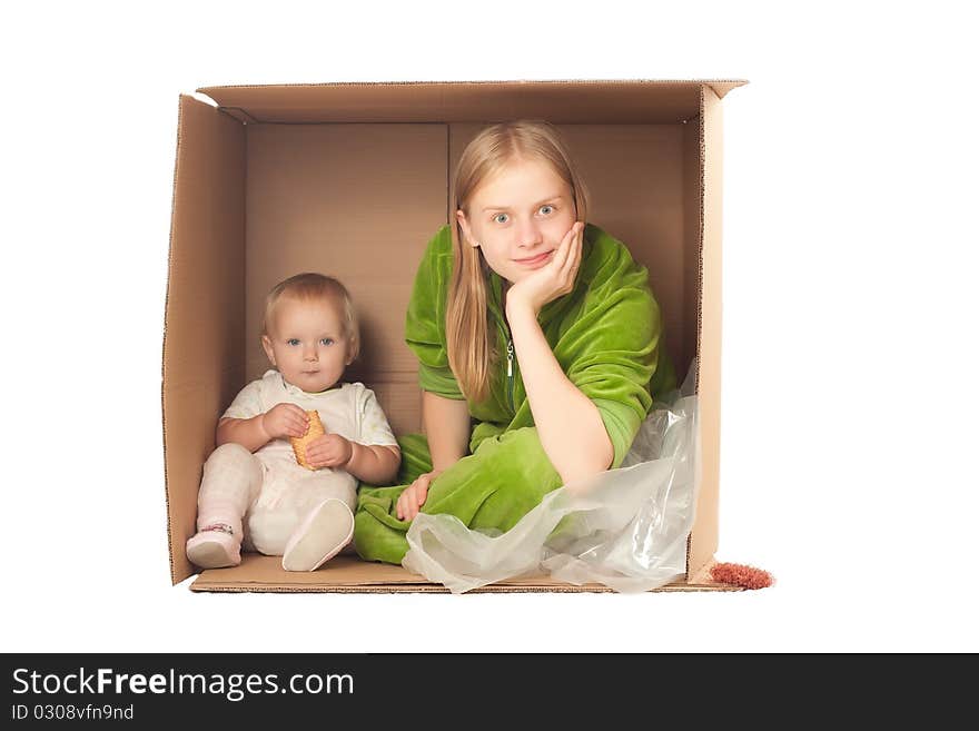 Mother in box with baby eating cookie