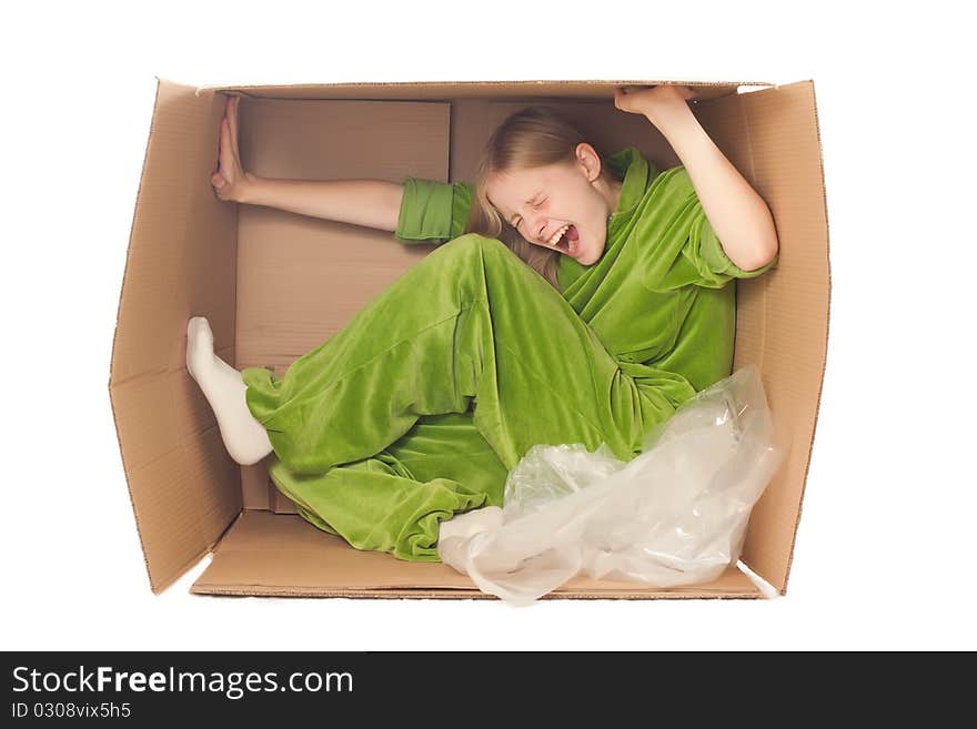 Young adorable woman sit in paper box and stretch it by hands and legs. Young adorable woman sit in paper box and stretch it by hands and legs