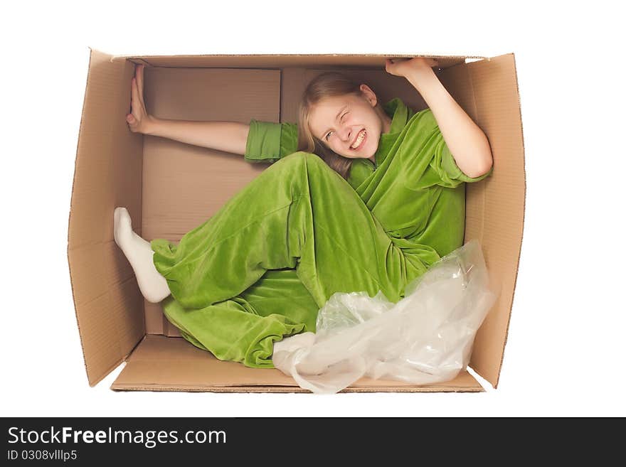 Young adorable woman sit in paper box and strech it by hands and legs