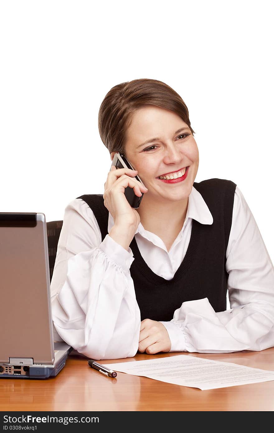 Young happy business woman calling at desk in office. Isolated on white background. Young happy business woman calling at desk in office. Isolated on white background.