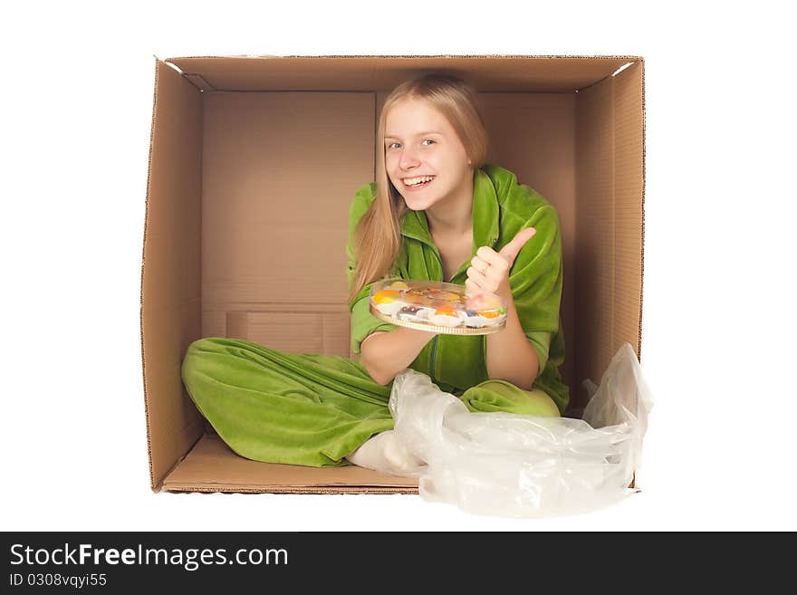 Young adorable woman sit in paper box and show plate with variety of fruits and berries. Young adorable woman sit in paper box and show plate with variety of fruits and berries