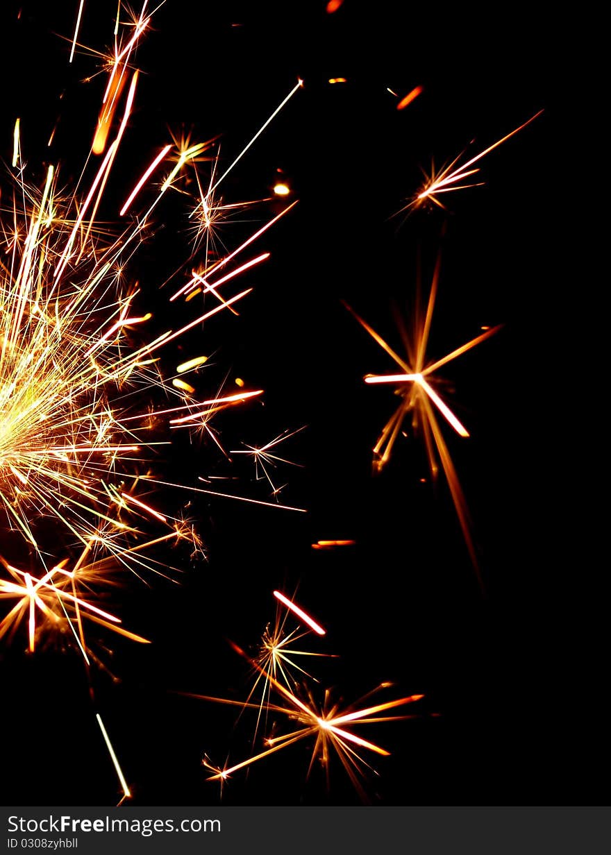 Golden sparkler on black background