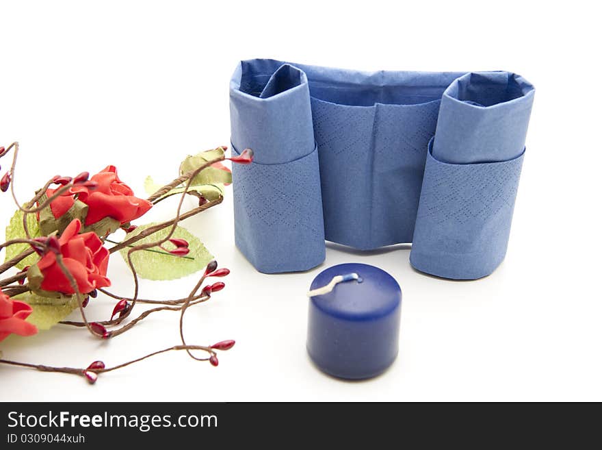 Napkin folded with candle and flowers