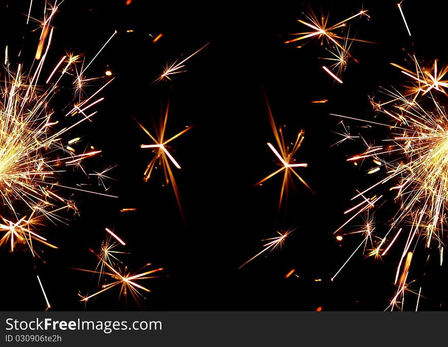 Golden sparkler on black background